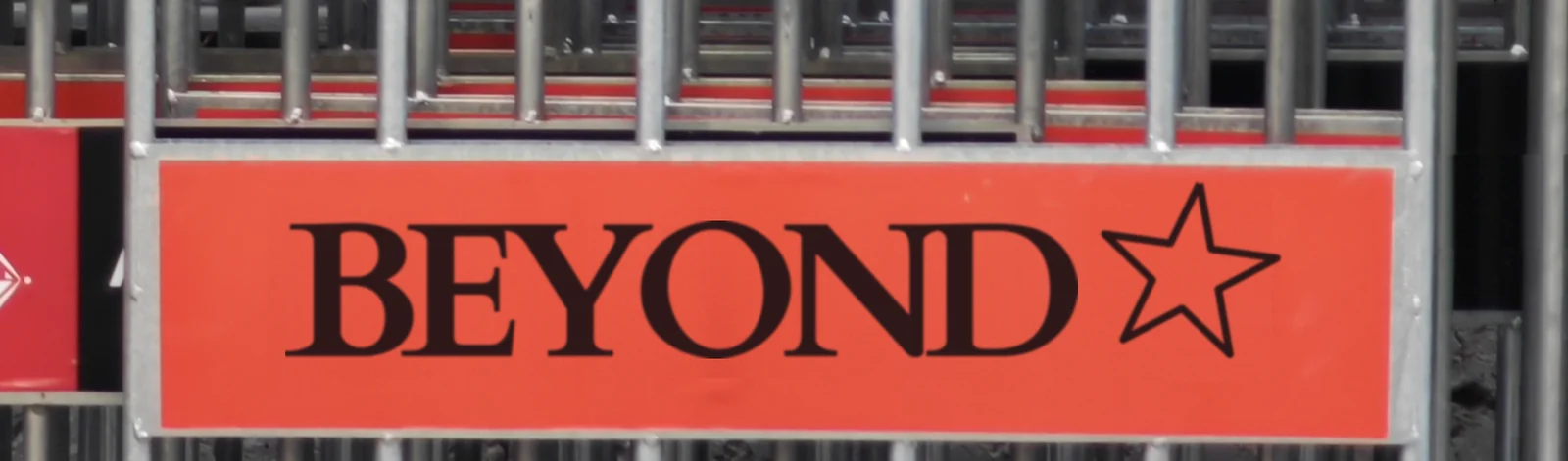A red Barcelona street sign reading BEYOND