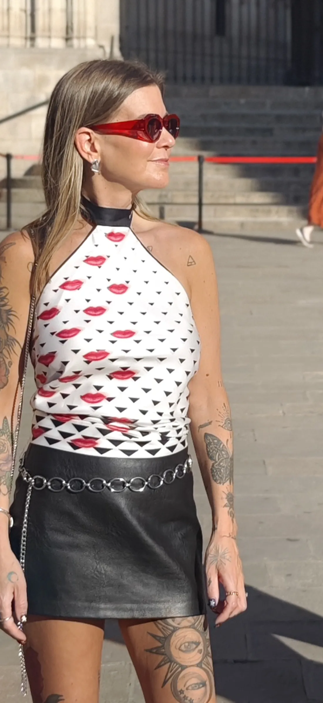 Cortnie in red sunglasses and a red lips halter top on a Barcelona plaza